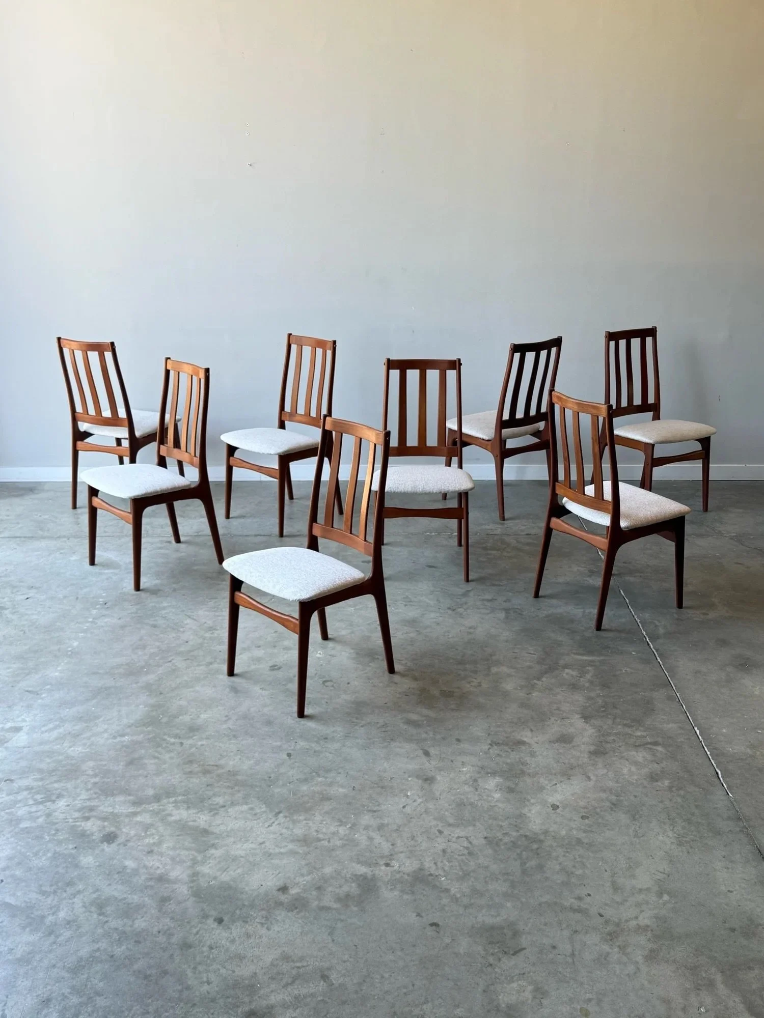 AVAILABLE ~ Mid-century set of eight dining chairs. Designed by Schi&oslash;nning &amp; Elgaard, Denmark. Made from teak wood and newly reupholstered. 

This set features a high-back slat design. The backs are ergonomic providing great support. The b
