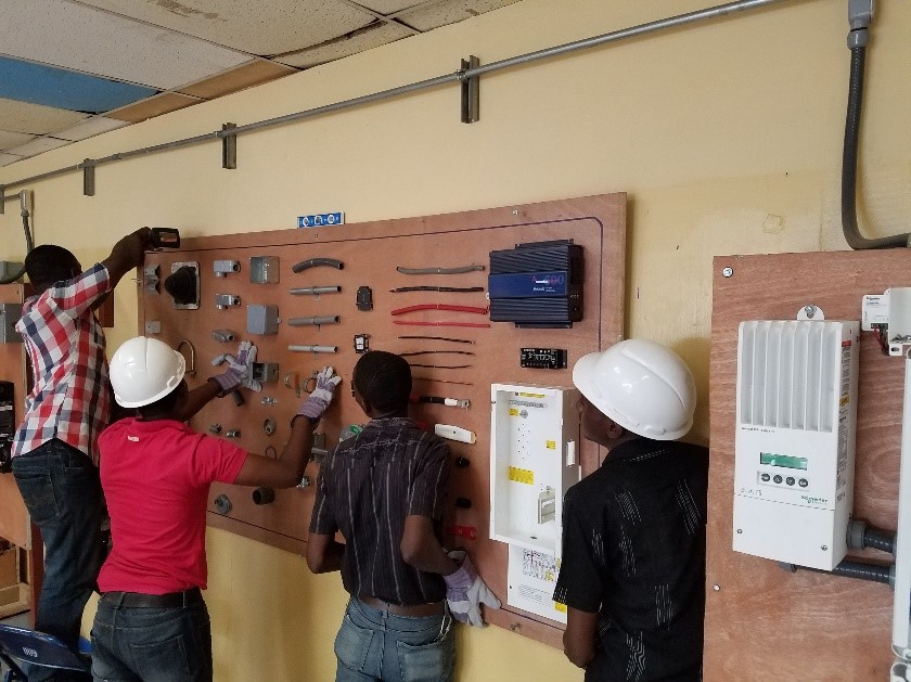  Haiti Tec teachers prepping the classroom with a display board. 