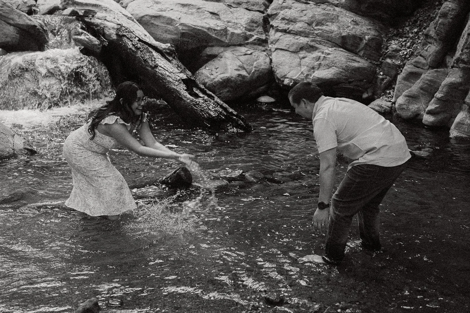 Southern California elopement photographer captures bride and groom kissing at the top of heart rock trail in crestline California. this moody, rich edit takes place at the top of the rocks near big bear lake