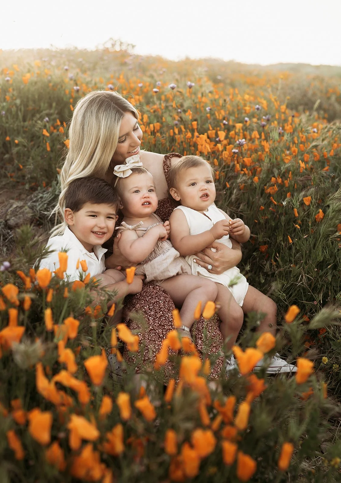 Southern California Photographer captures mom with her three children in a poppy covered hill in riverside California