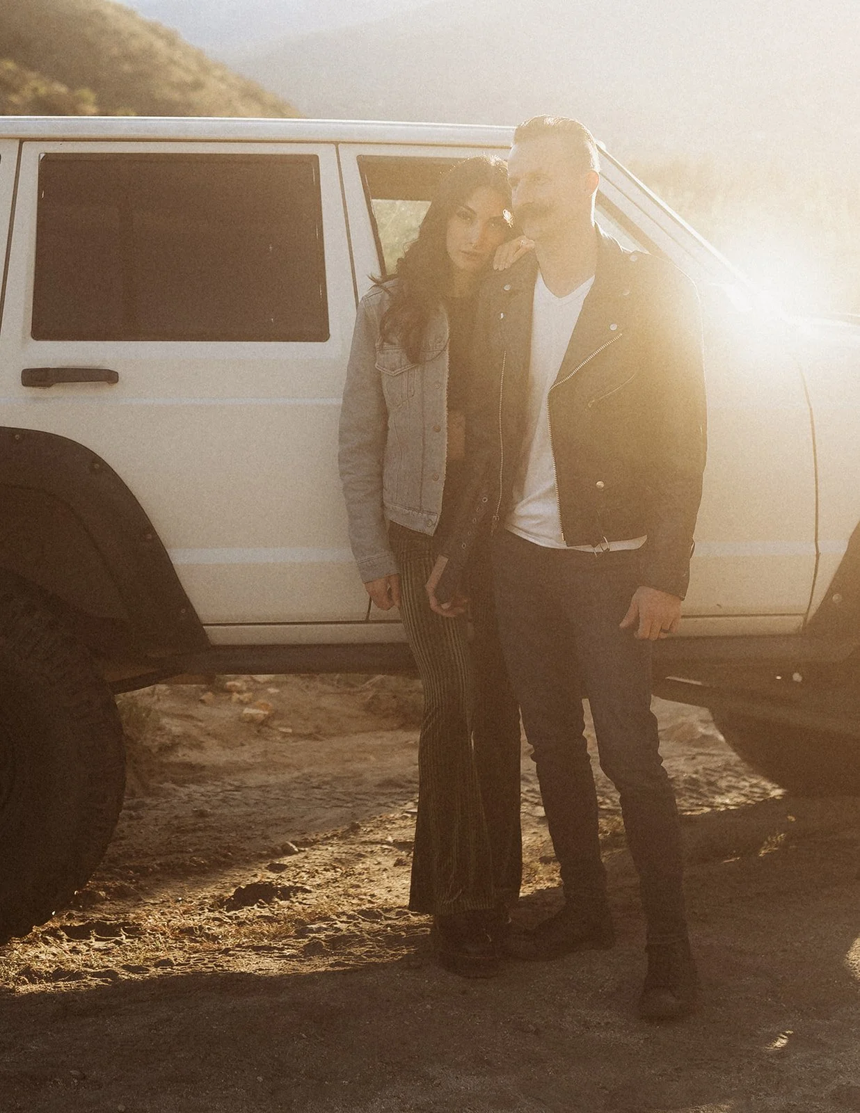 Southern California elopement photographer captures couple in jeep xj near Joshua tree national park. this moody rich edit is full of warm browns