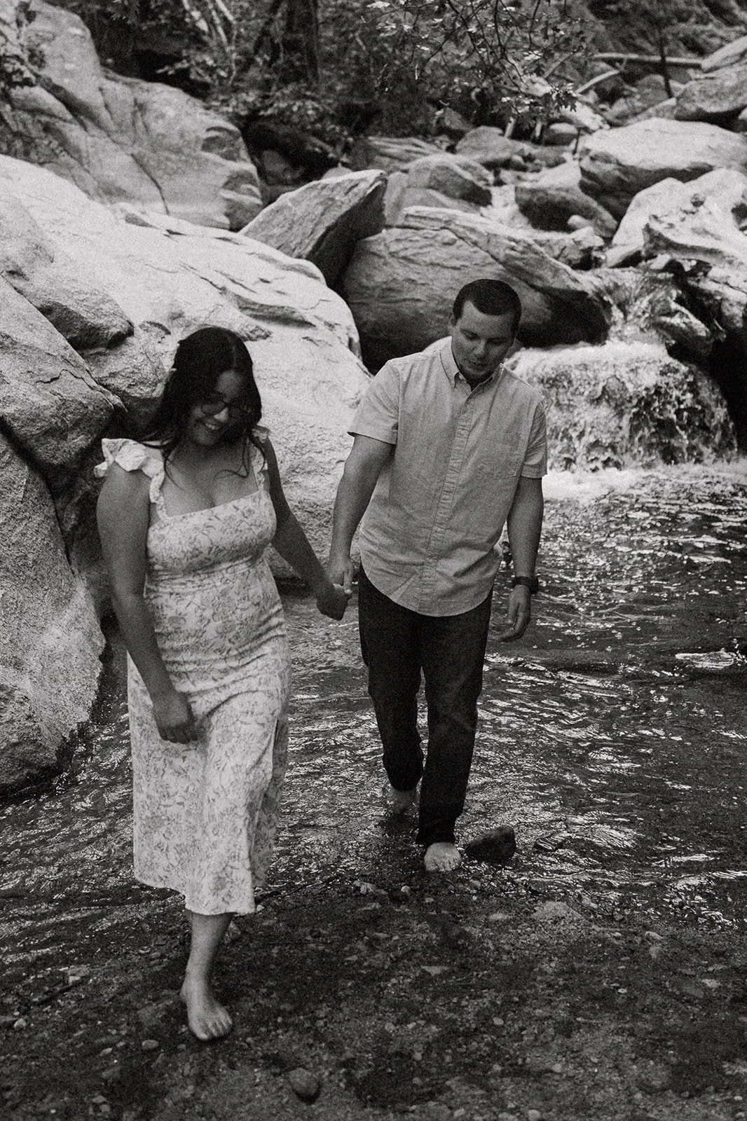 Southern California elopement photographer captures bride and groom kissing at the top of heart rock trail in crestline California. this moody, rich edit takes place at the top of the rocks near big bear lake