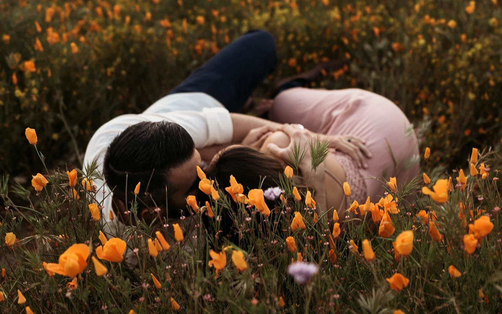 Southern California elopement photographer captures couple in a poppy field during sunset. this moody, rich edit is in Riverside California.