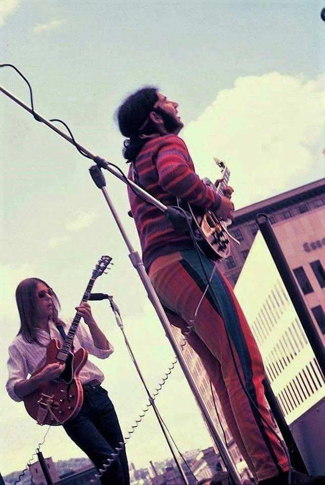 Two men playing guitar at an outdoor concert