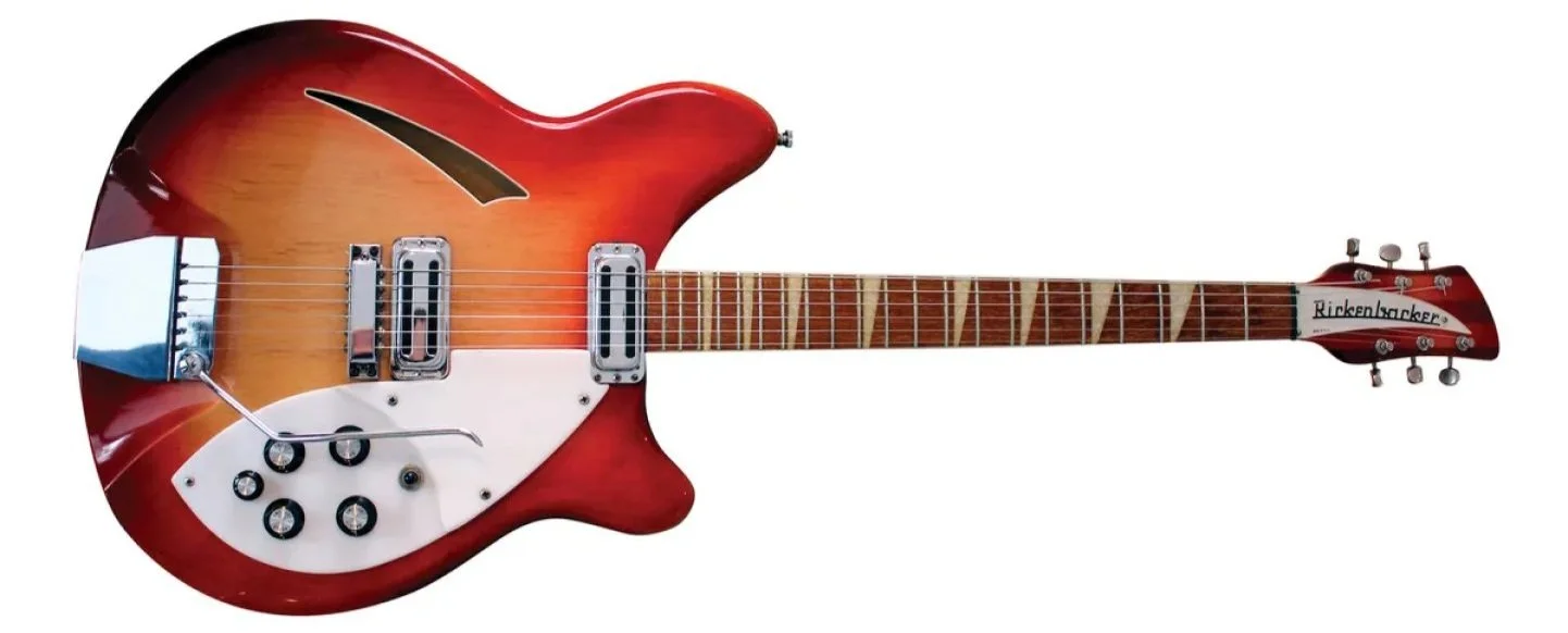 A futuristic-looking electric guitar with red and orange burst finish