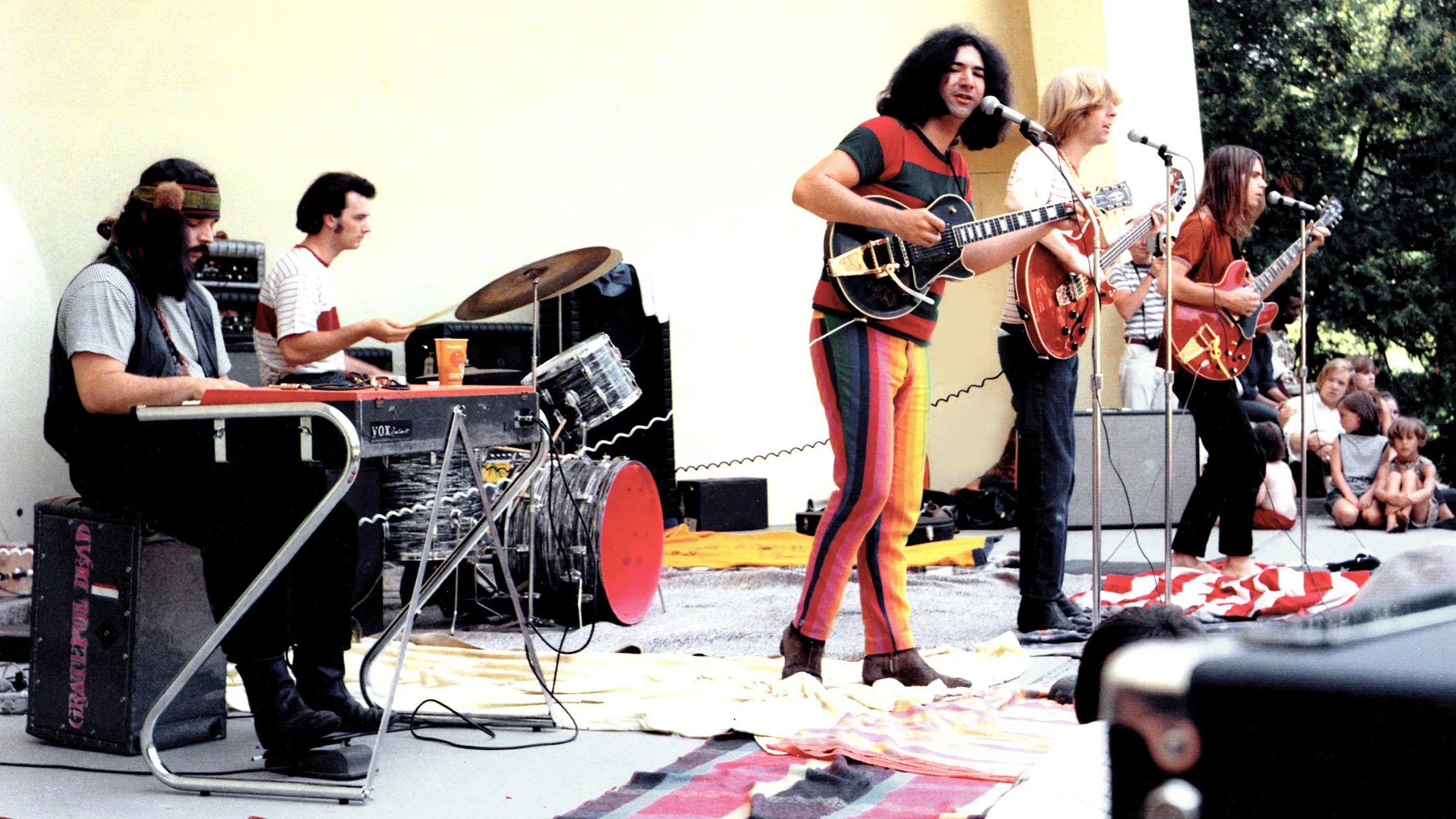 A band wearing colorful clothes and playing a concert