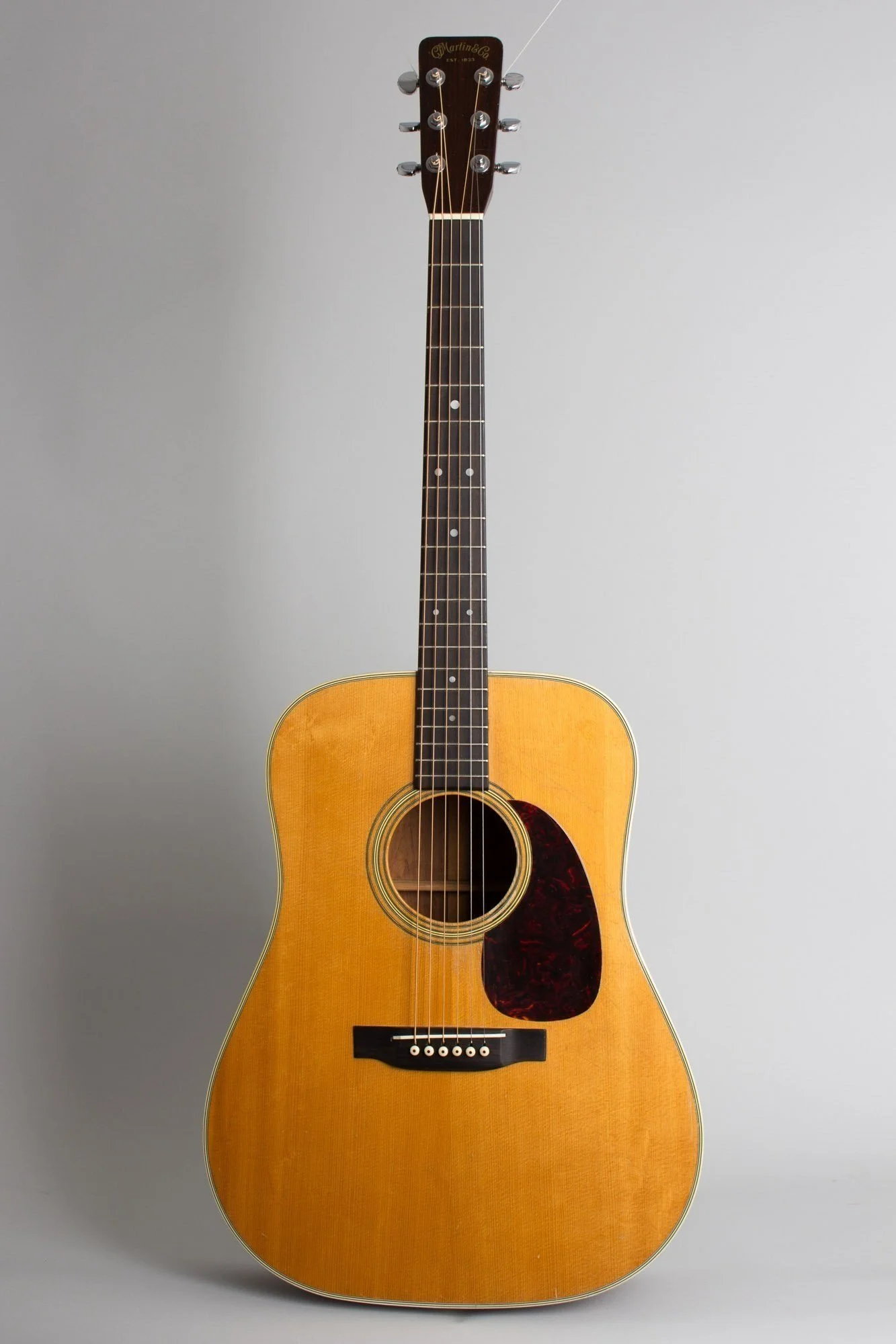 A dreadnought-shaped acoustic guitar with a light wood finish