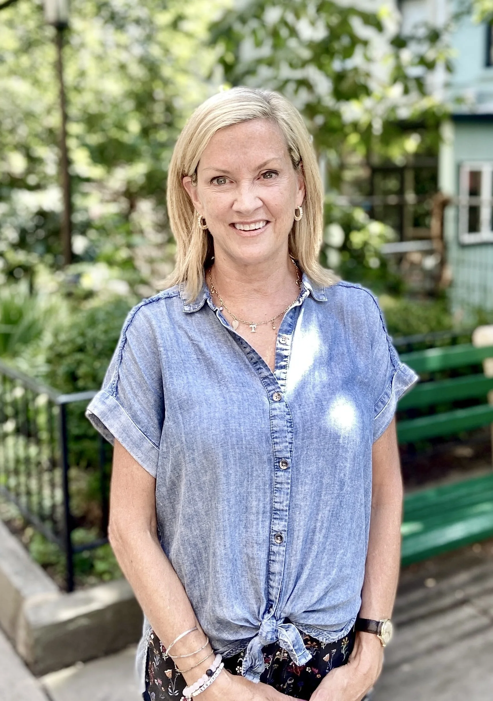 a person in a blue shirt smiling outside