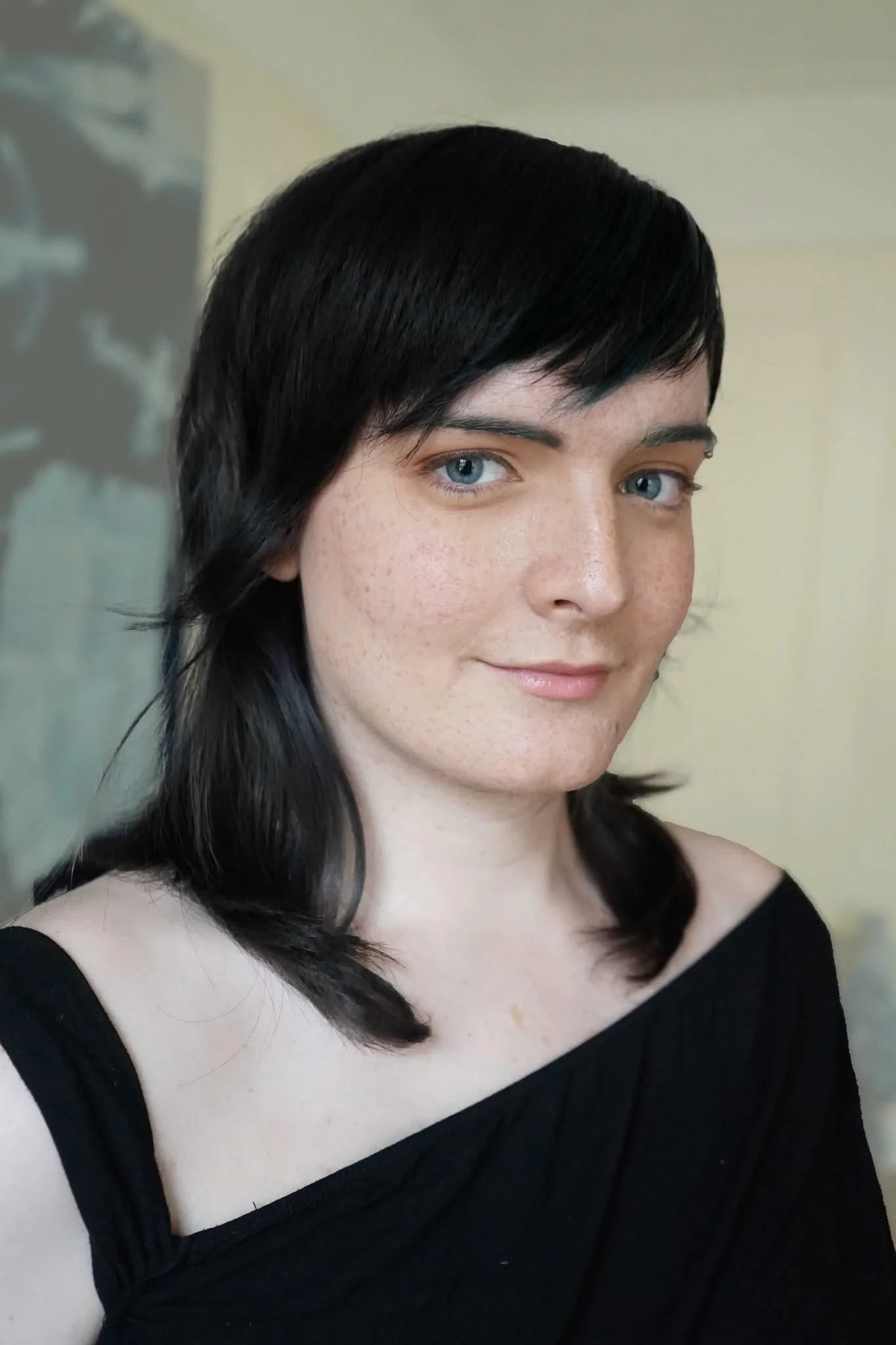 a person with dark hair smiling