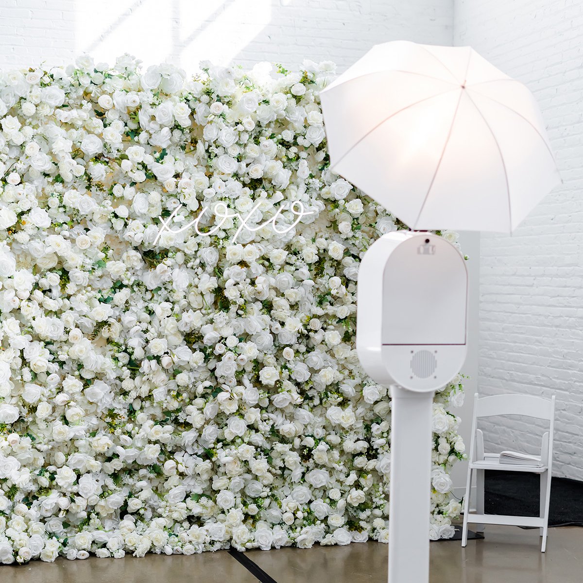 photo-booth-with-flower-wall-and-neon-sign_square-crop.jpg