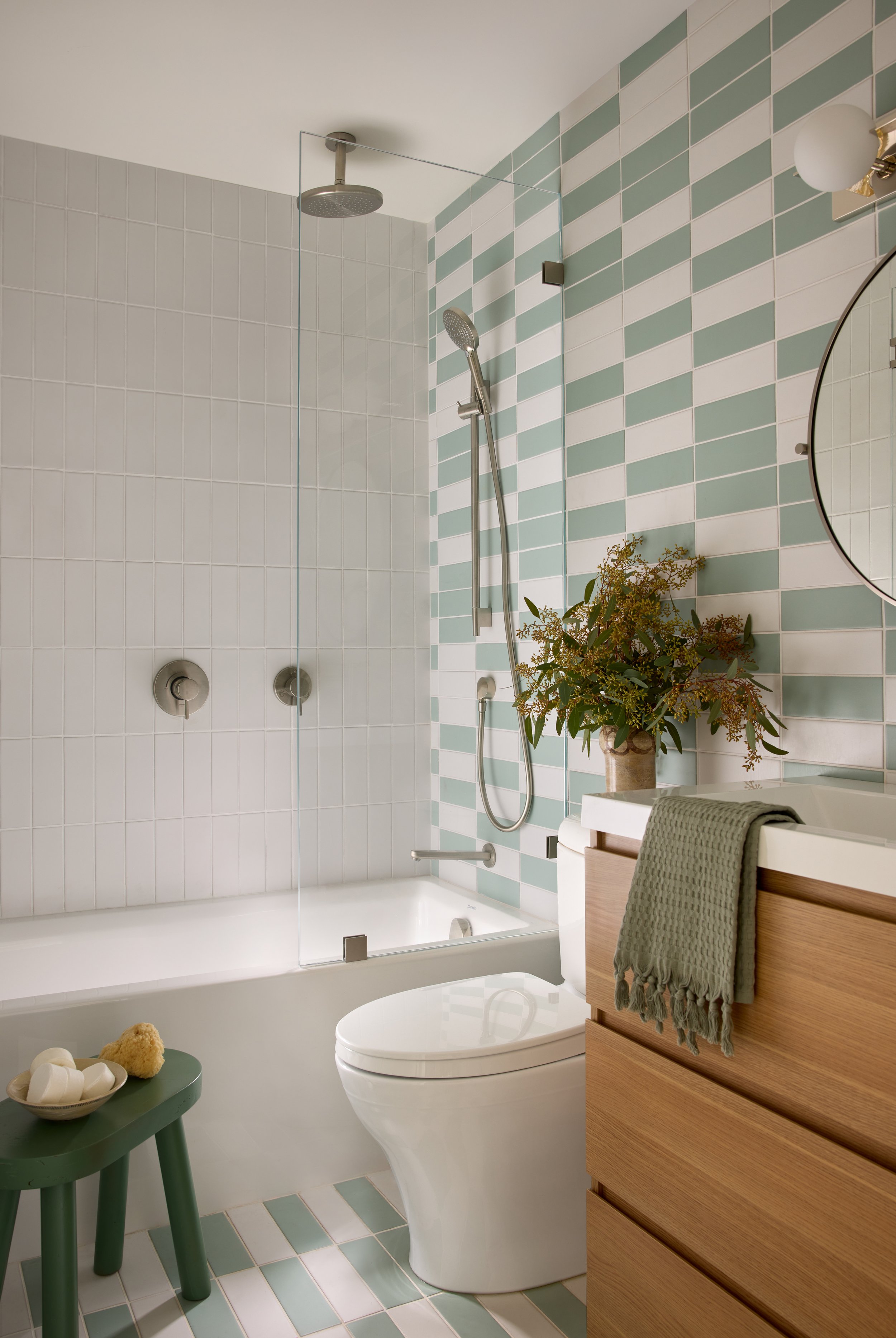 Residential bathroom with white and green tile