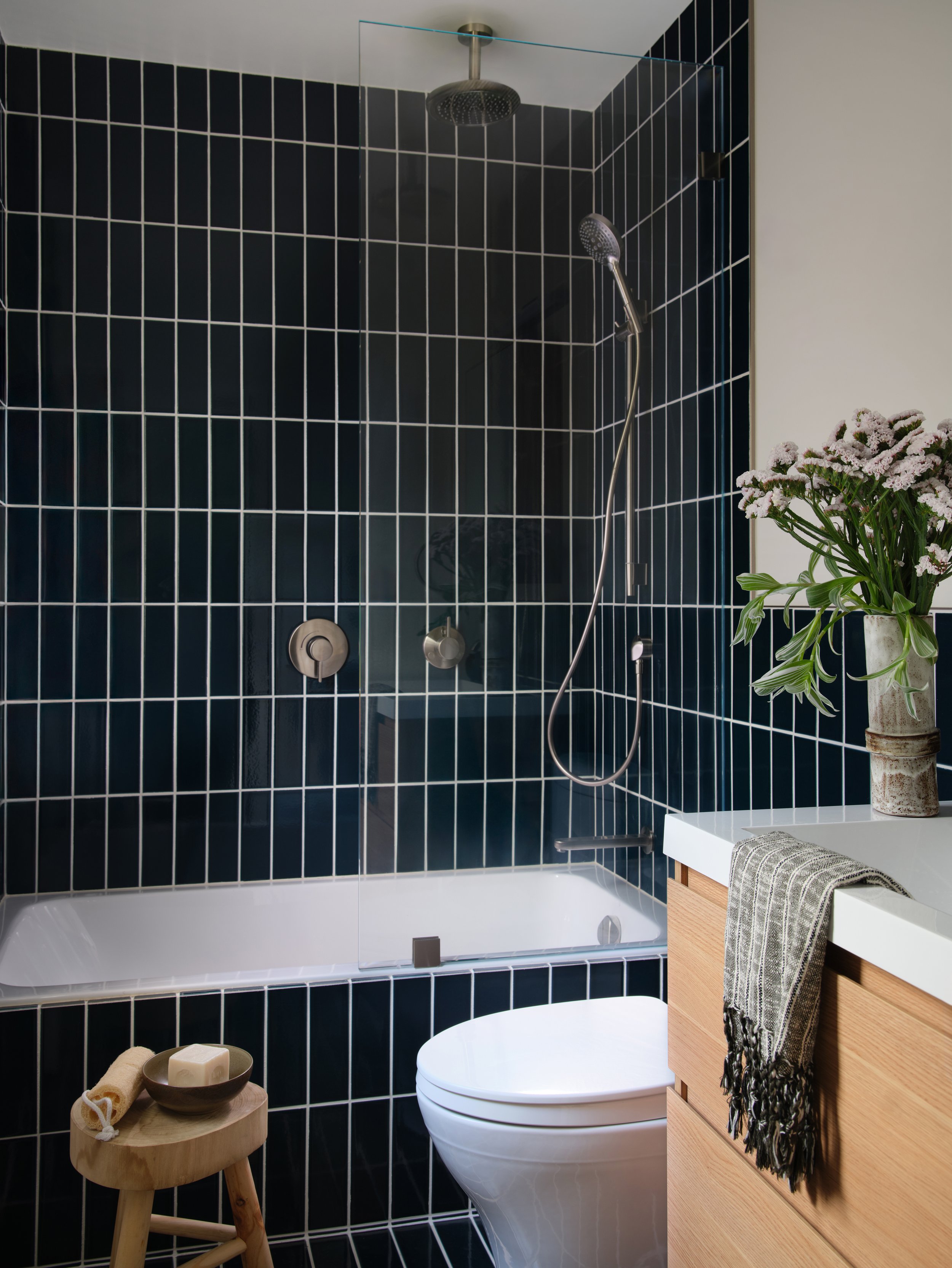 Residential bathroom with dark blue tile