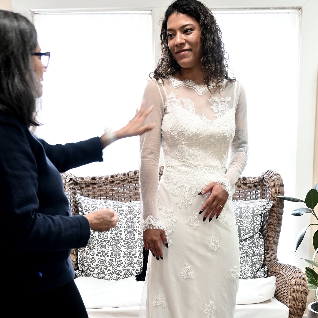 Maria fitting a model in a dress from her new collection, Midnight Flower—a beautiful example of her attention to detail, craftsmanship, and timeless style.