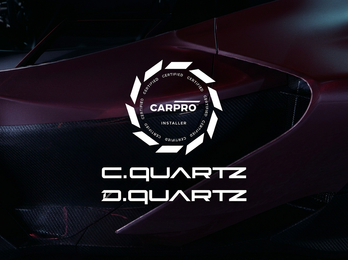 Close-up of a sports car with a logo overlay reading CARPRO Certified Installer surrounded by a ring of arrows, over a dark maroon body with black carbon fiber accents, and text indicating C. Quartz and D. Quartz.