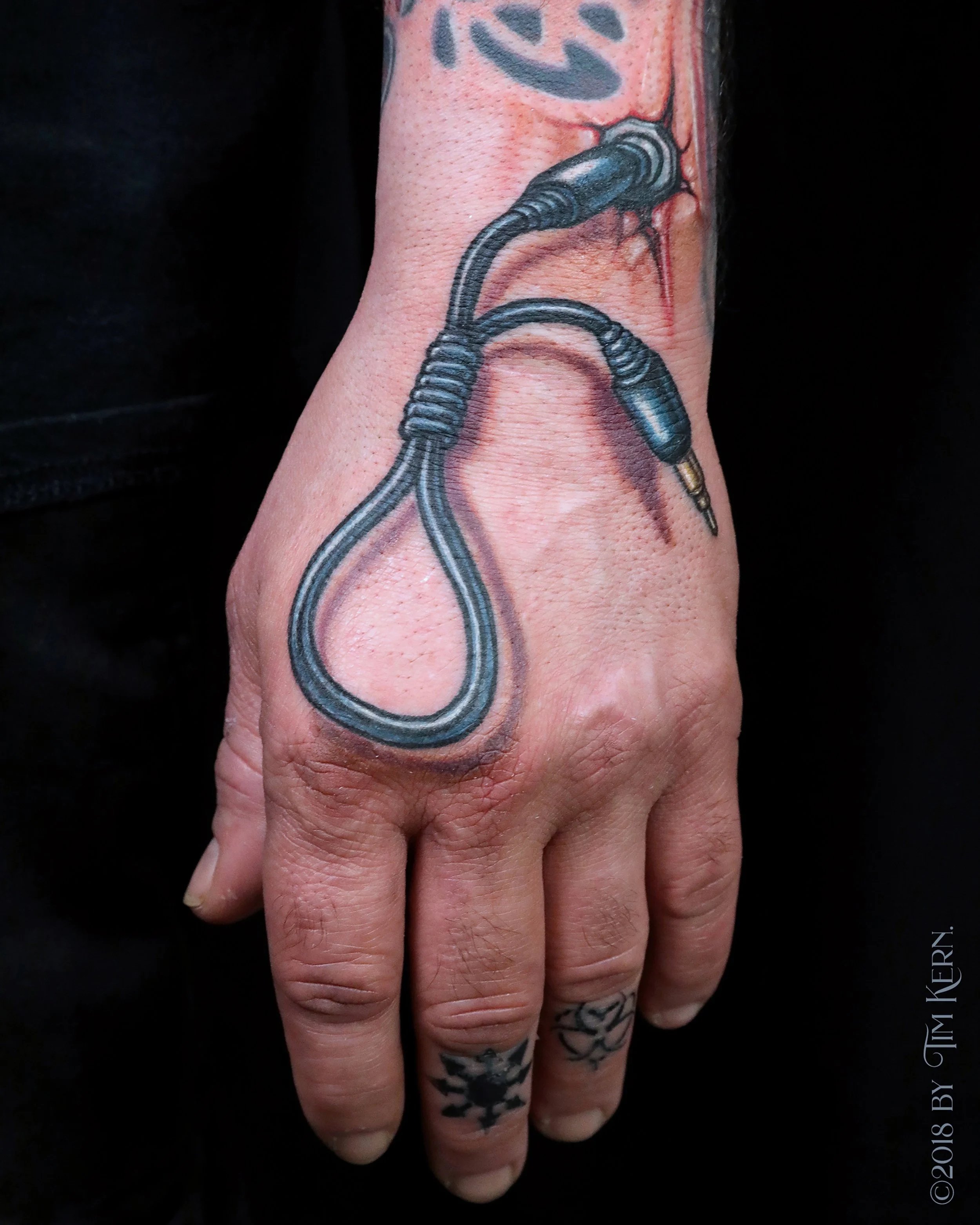 Speaker-Plug-Noose-DJ-Hand-Tattoo.jpg