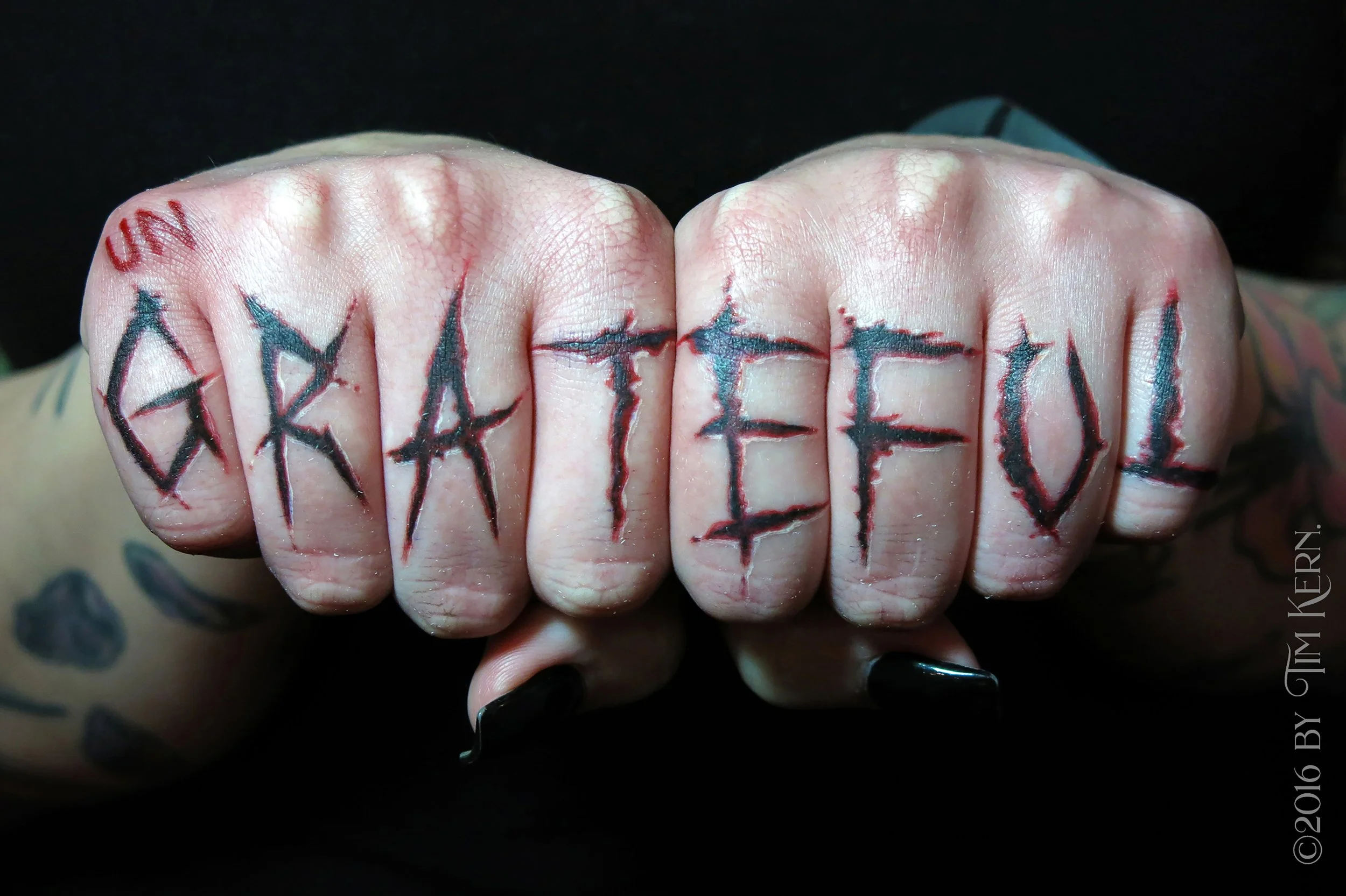 Ungrateful-Lettering-Knuckle-Duster-Carved-Finger-Tattoo.jpg