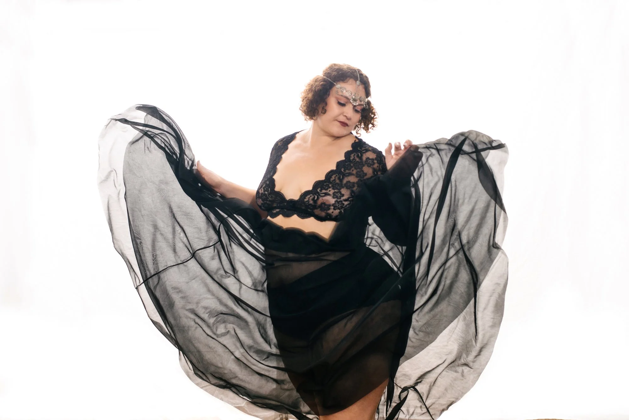 Woman moving during boudoir session 