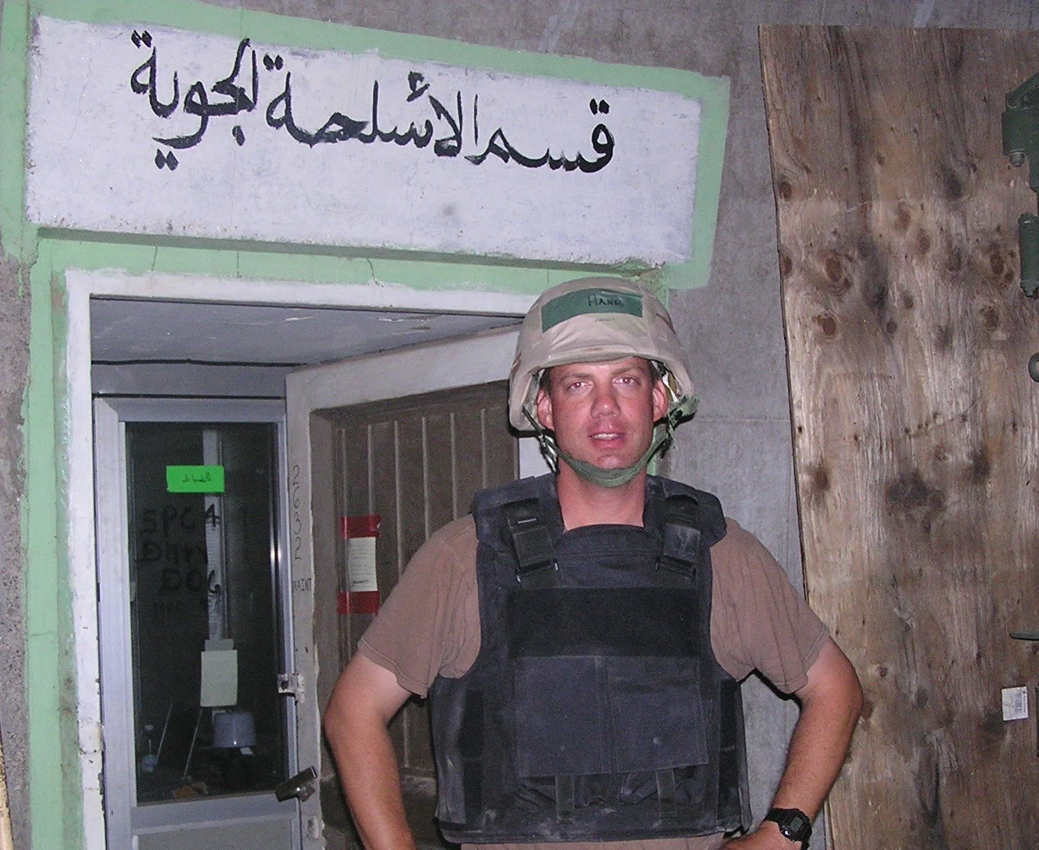 Ron in front of "Air Weapons Section" (qsm alaslh? aljwi? in Arabic) MiG-23 hanger, Balad SE, Iraq 2003