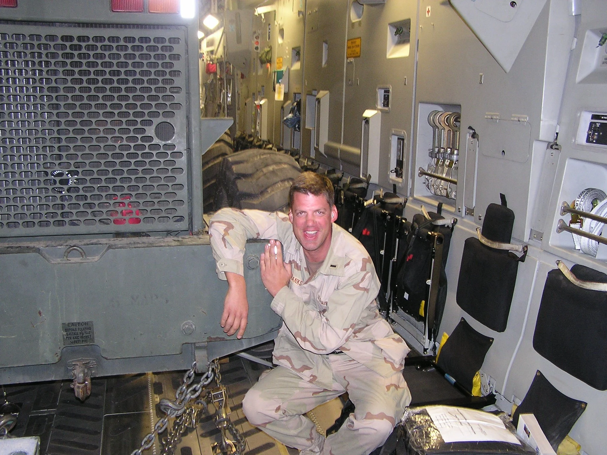 Ron with John Deere articulated loader onboard C-17 to Iraq, 2003