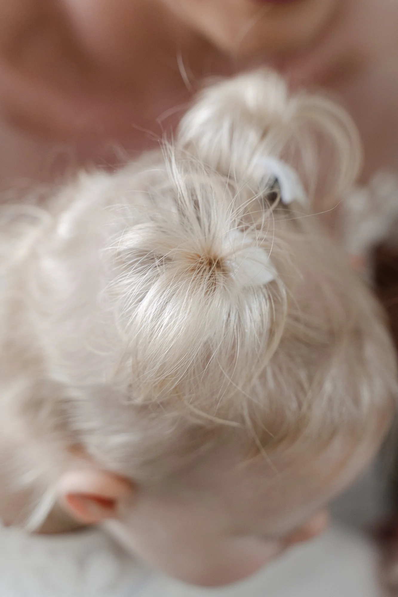 Close-up of a small child, being held close by a bride.