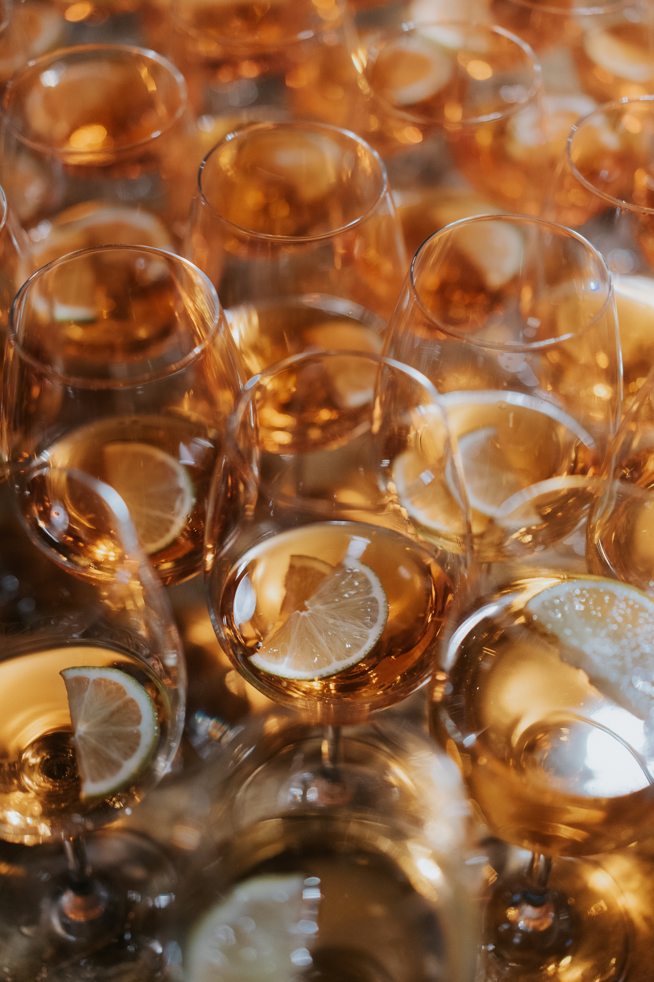 Multiple glasses of sparkling rose wine with lemon slices. Alto Event Space
