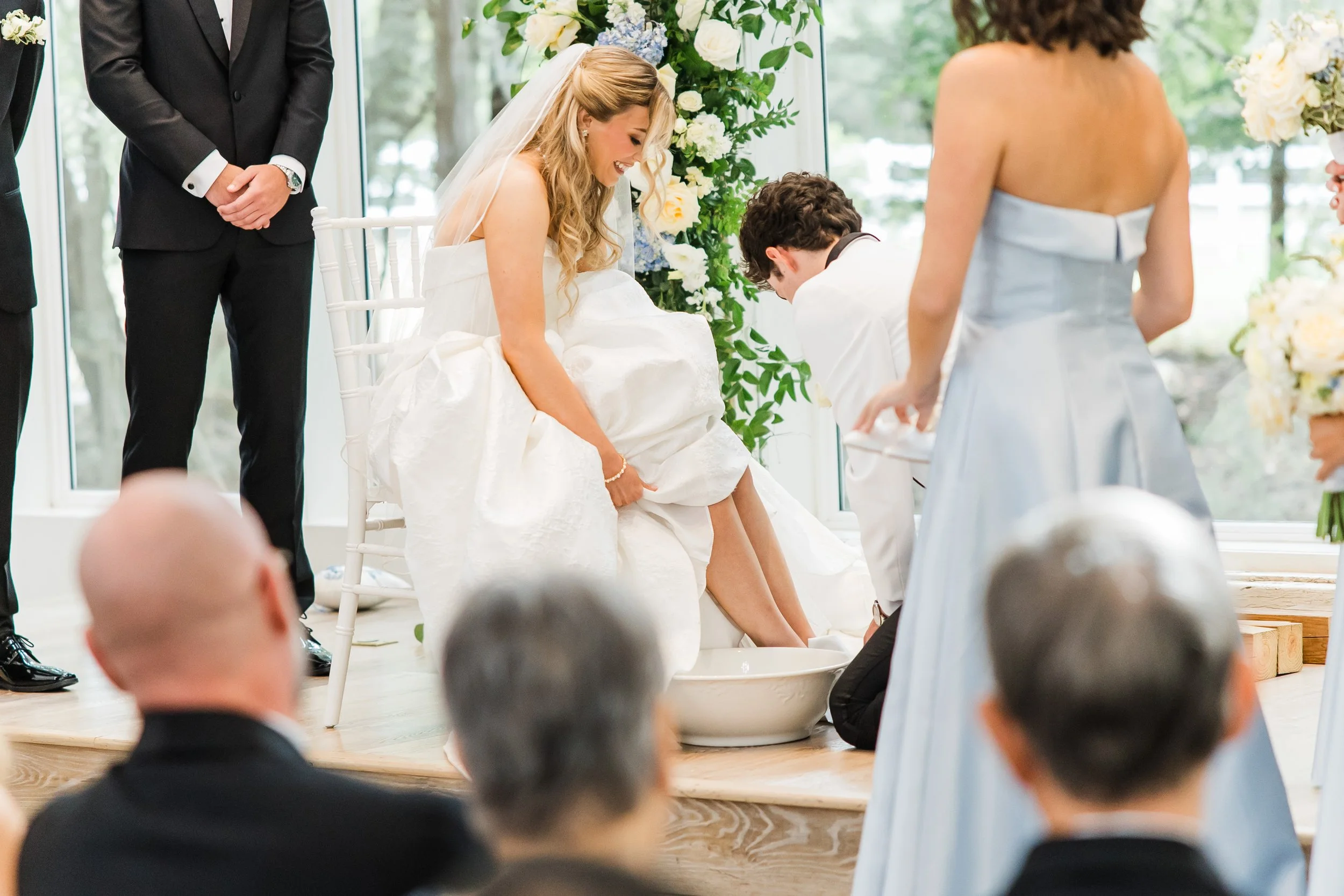 Biblical foot-washing ceremony during the ceremony at the French Farmhouse Venue in Collinsville, TX