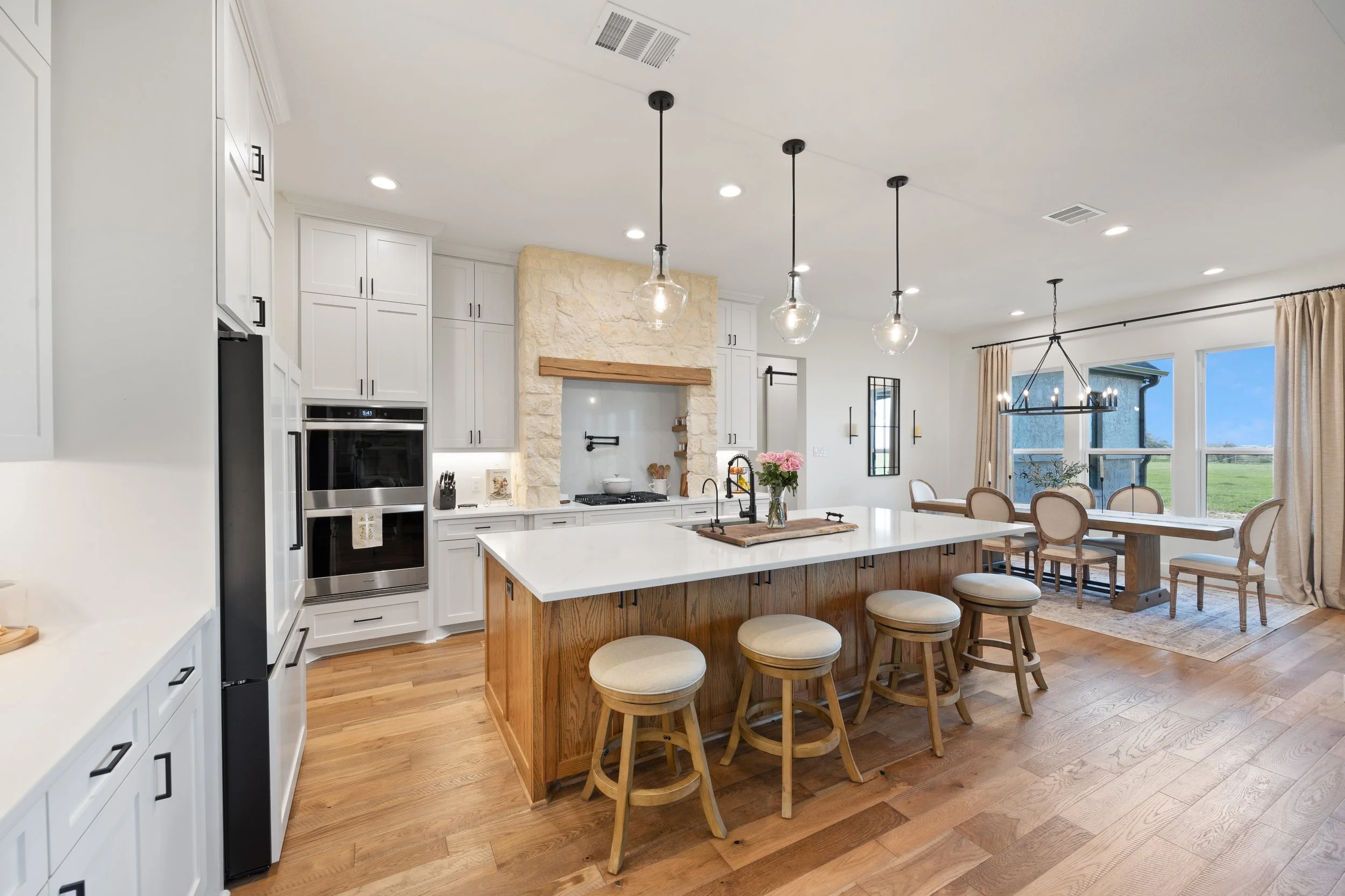Luxury custom Ranch home in DFW with open kitchen and stone stove surround