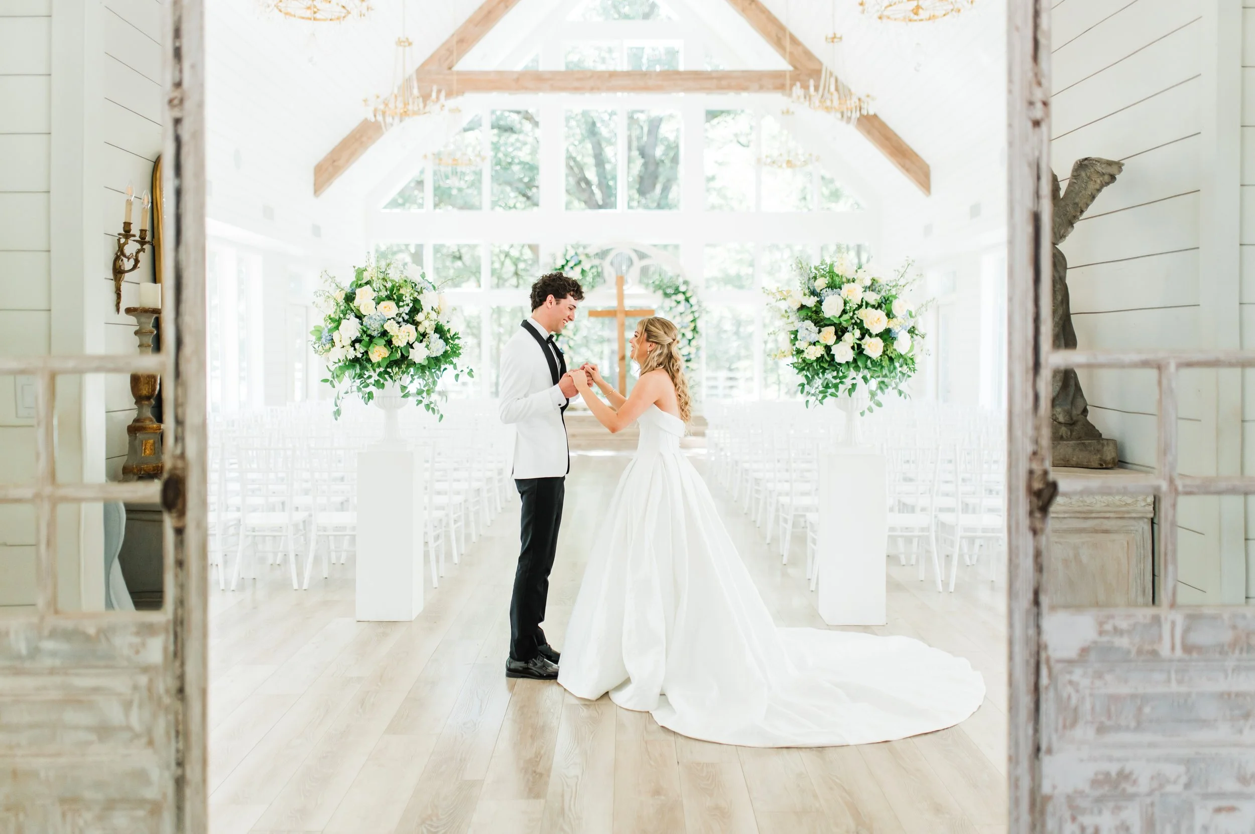 Bride's emotional first look with her groom in the chapel at the french farmhouse venue in collinsville tx