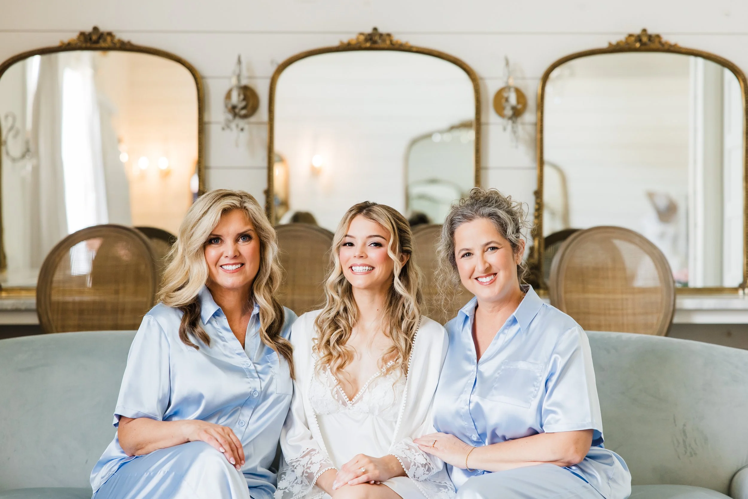 Bride getting ready with moms and bridesmaids inside The French Farmhouse bridal suite