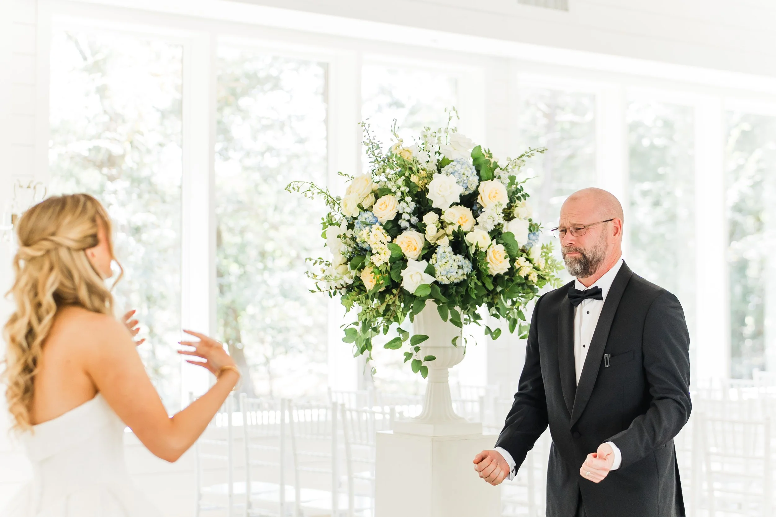 Bride's first look with her dad in the chapel at the french farmhouse venue in collinsville tx
