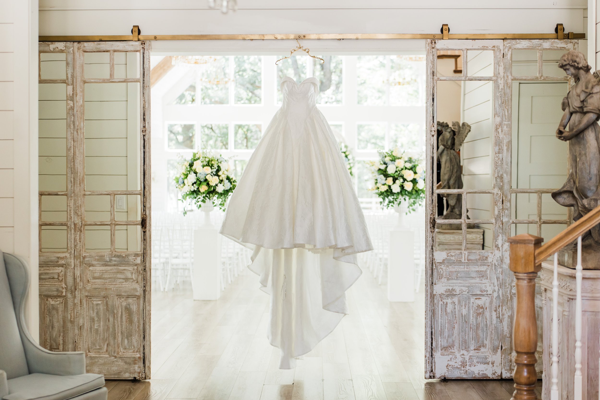 Dress hanging in chapel doorway at the French Farmhouse Venue in Collinsville TX