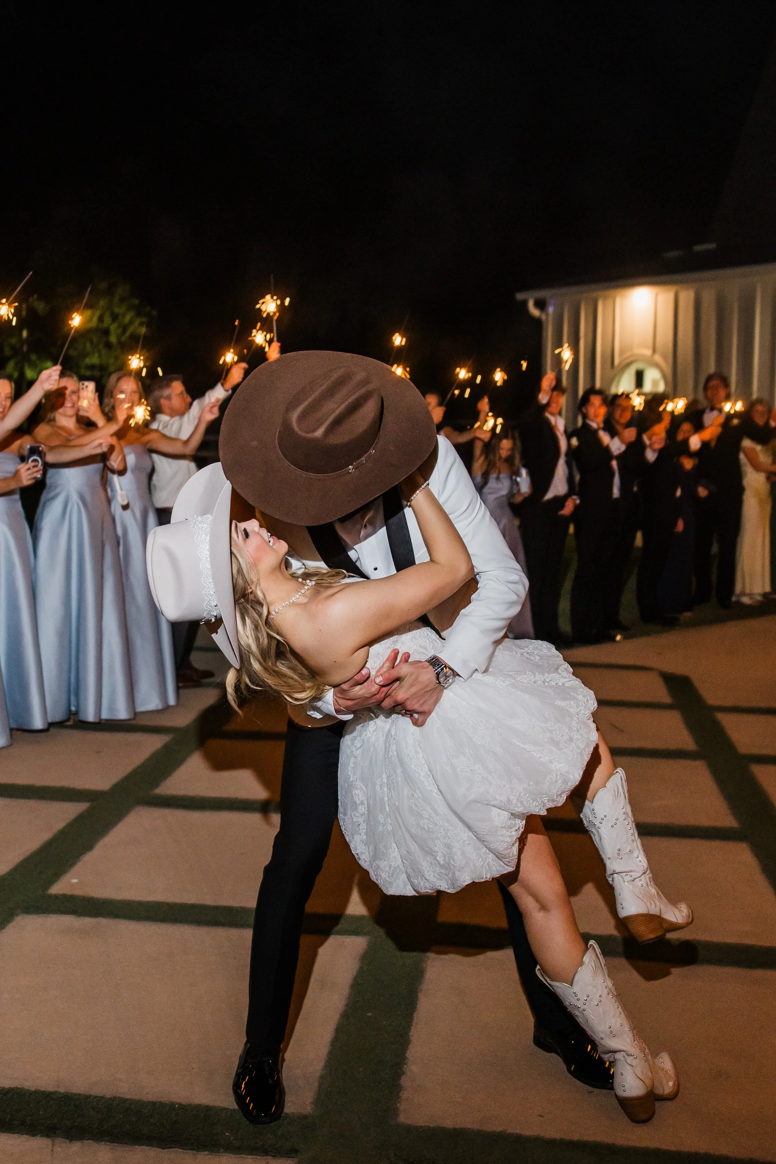 Dip kiss during sparkler exit at French Farmhouse Venue in Collinsville TX