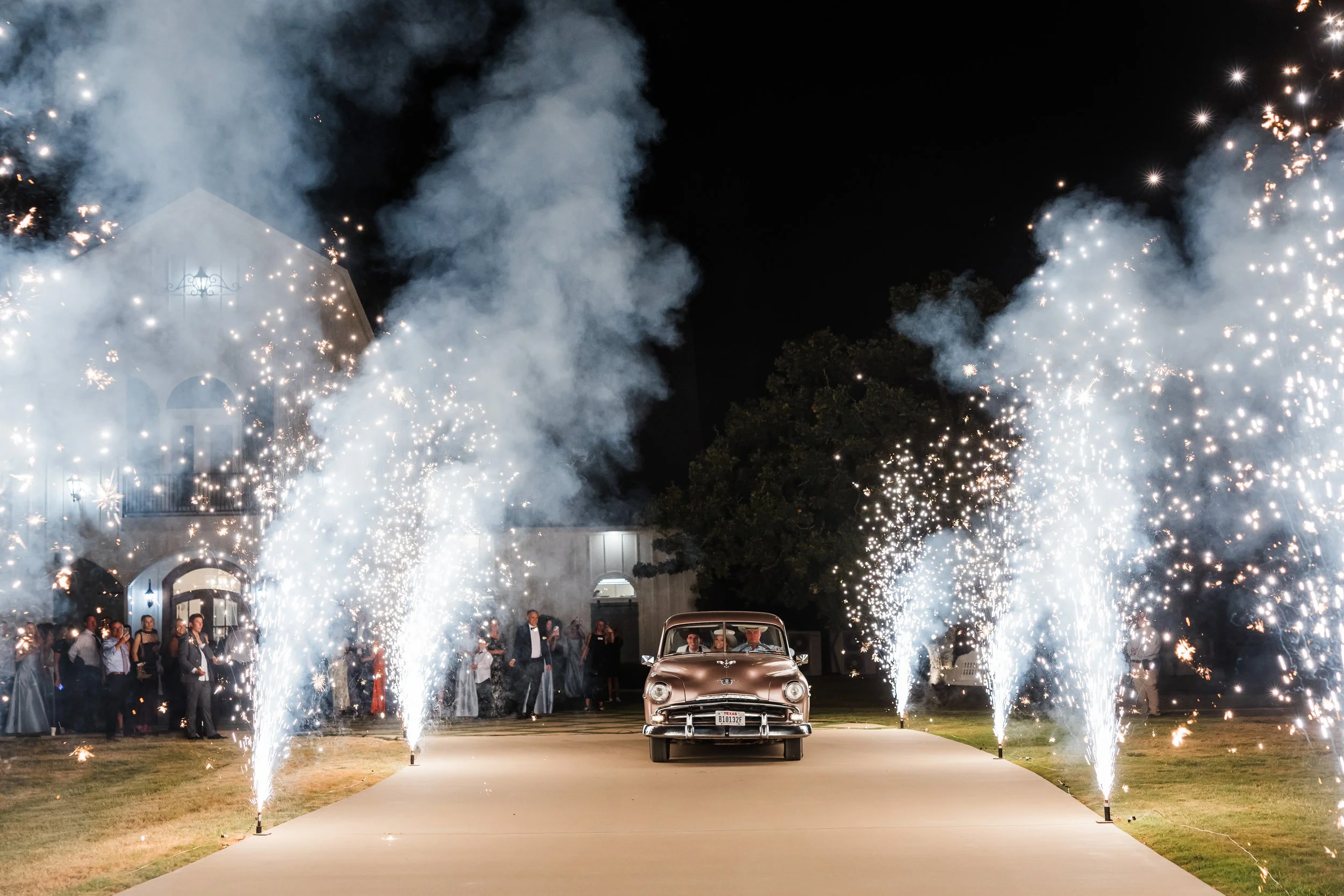 Vintage getaway car exit through fireworks from PyroTex at the French Farmhouse Venue in Collinsville TX