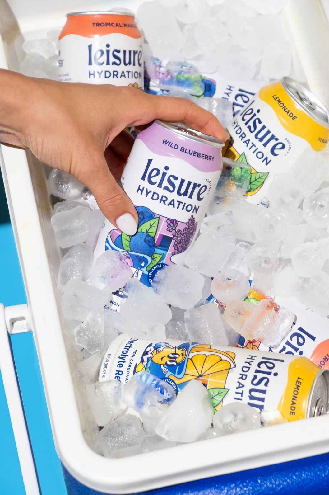 Seattle drink product photography of a blue cooler full of flavored water cans with a hand reaching in to grab one of the cans