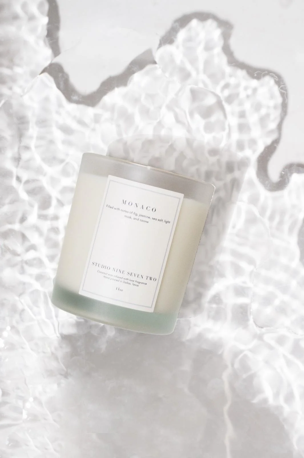 Seattle candle product photography of a white candle on rippling water