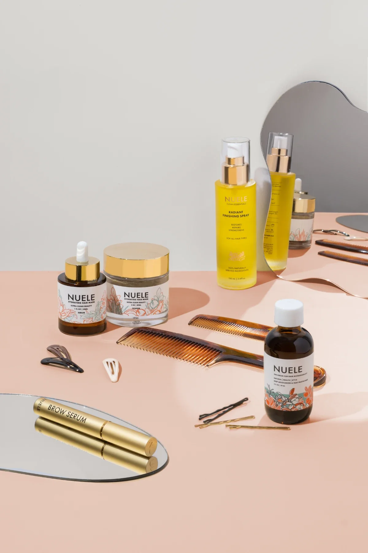 Haircare product photography of bottles, jar, and serum with hair accessories, small mirrors. Photo for e-commerce, campaigns, and marketing.