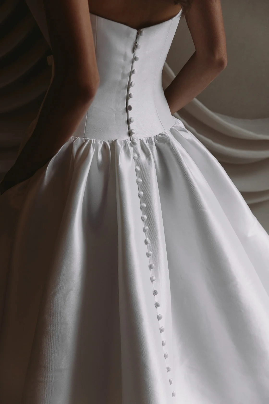 Aneta by Trish Peng stretch Mikado wedding dress featuring a modern drop waist, expertly ruched bodice and elegant A-line skirt, available at Spellbound Bridal Ireland.