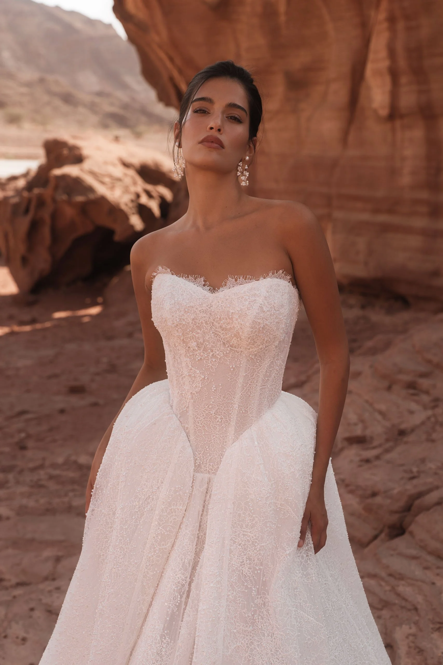 Discover the Betta wedding dress at Spellbound Bridal. A strapless princess gown in Chantilly lace with pearl detailing, voluminous skirt and detachable ruffles. Try her on in Wicklow, Ireland.