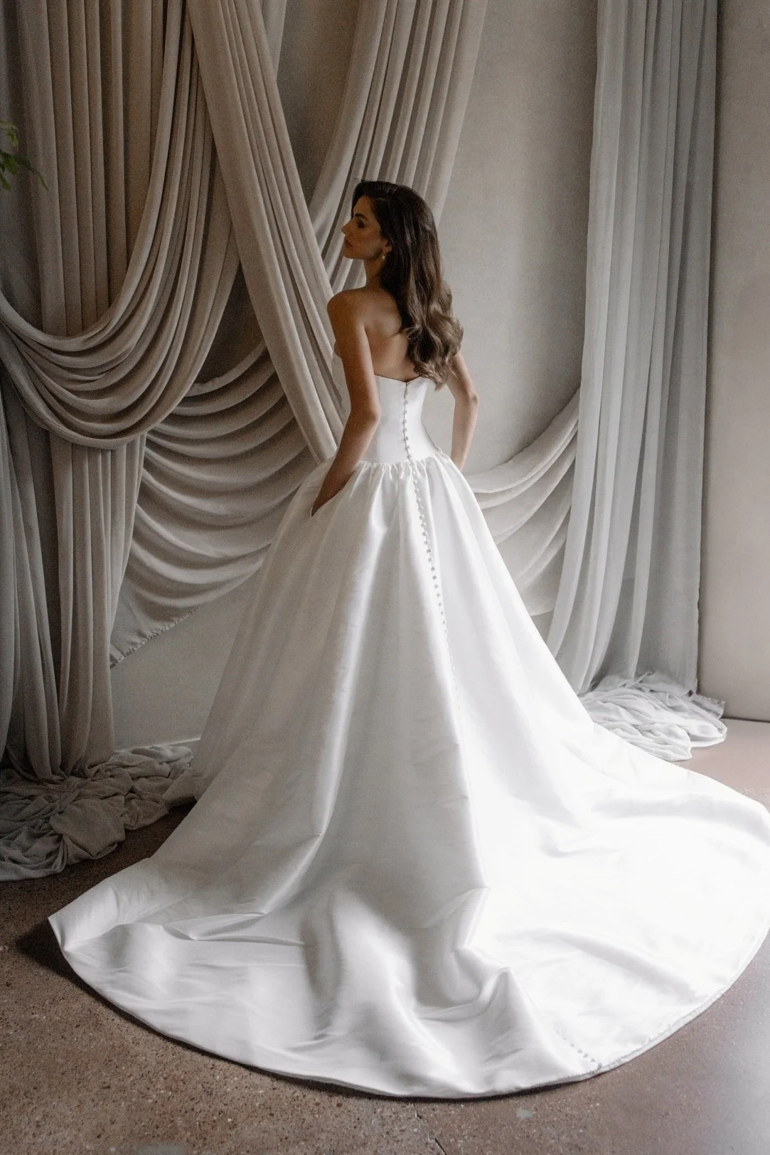 Aneta by Trish Peng stretch Mikado wedding dress featuring a modern drop waist, expertly ruched bodice and elegant A-line skirt, available at Spellbound Bridal Ireland.