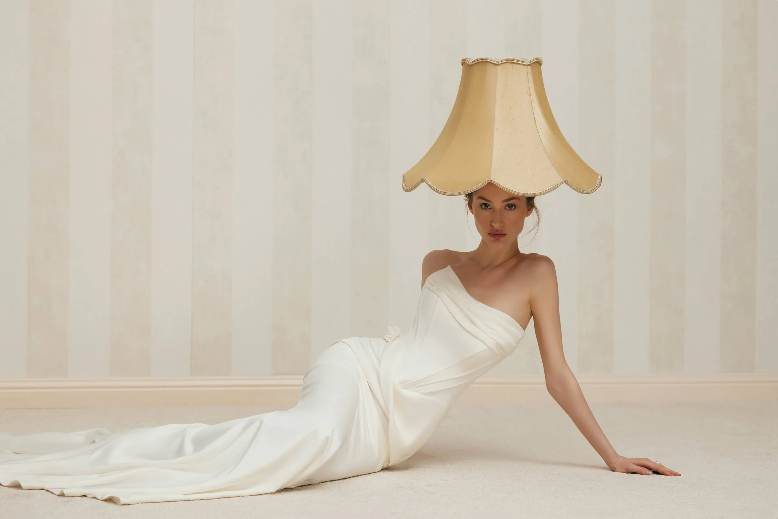 FENNA satin wedding dress by couture designer Anne-Mariée at Spellbound Bridal Ireland. A strapless fit and flare bridal gown featuring a softly draped straight neckline, structured corset bodice with sculpted seam detailing, an elegant draped waist 