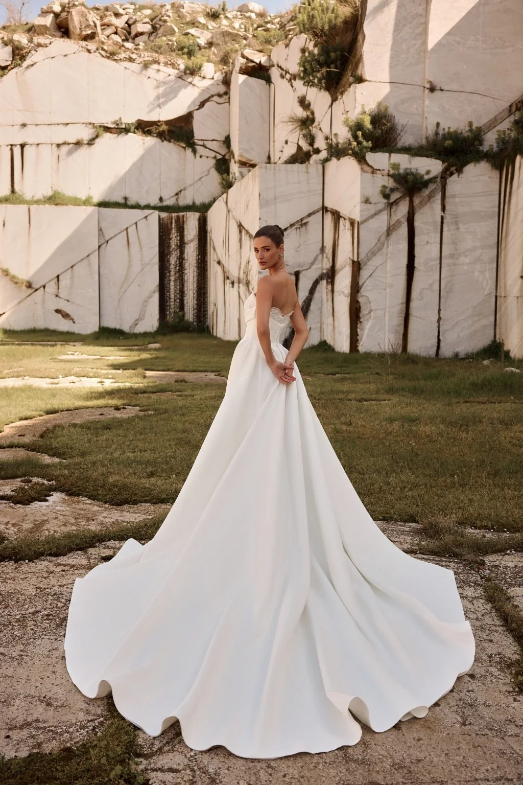 Discover Persephone by Katy Corso at Spellbound Bridal. An embellished guipure lace wedding dress with an optional sculpted corset overskirt for two striking bridal looks.