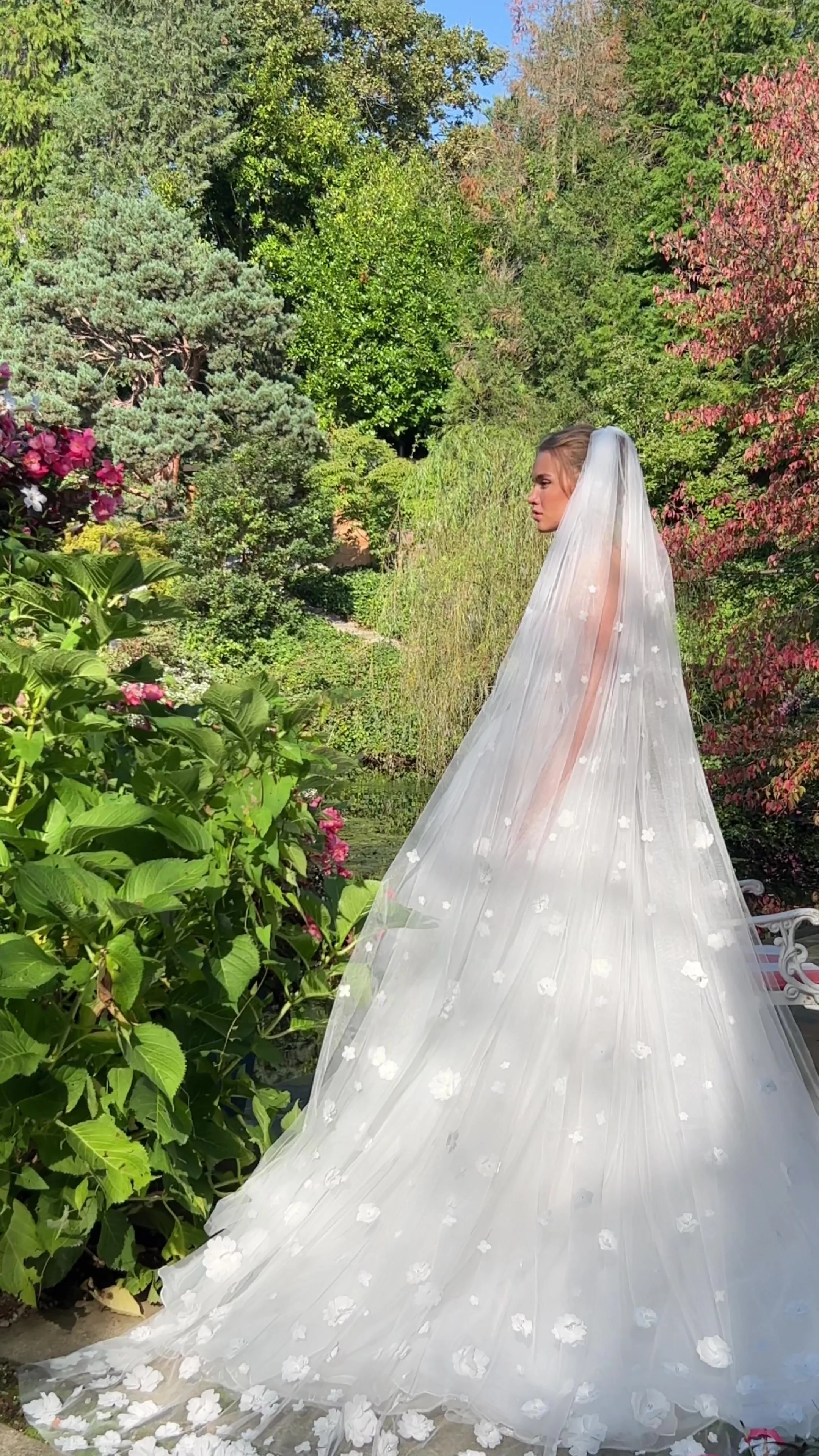Naomi cathedral-length bridal veil with delicate 3D floral appliqué on soft sheer tulle.