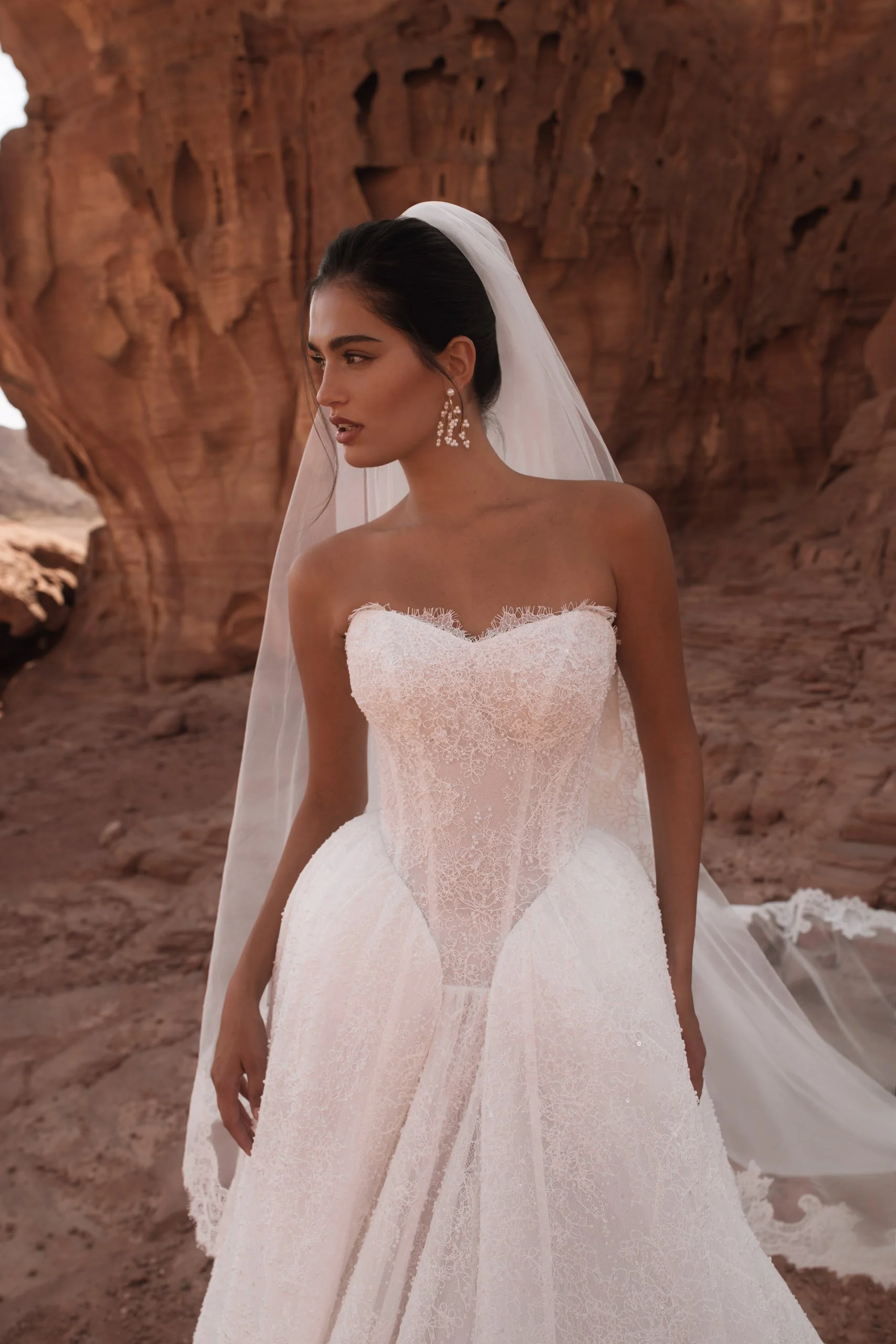 Discover the Betta wedding dress at Spellbound Bridal. A strapless princess gown in Chantilly lace with pearl detailing, voluminous skirt and detachable ruffles. Try her on in Wicklow, Ireland.