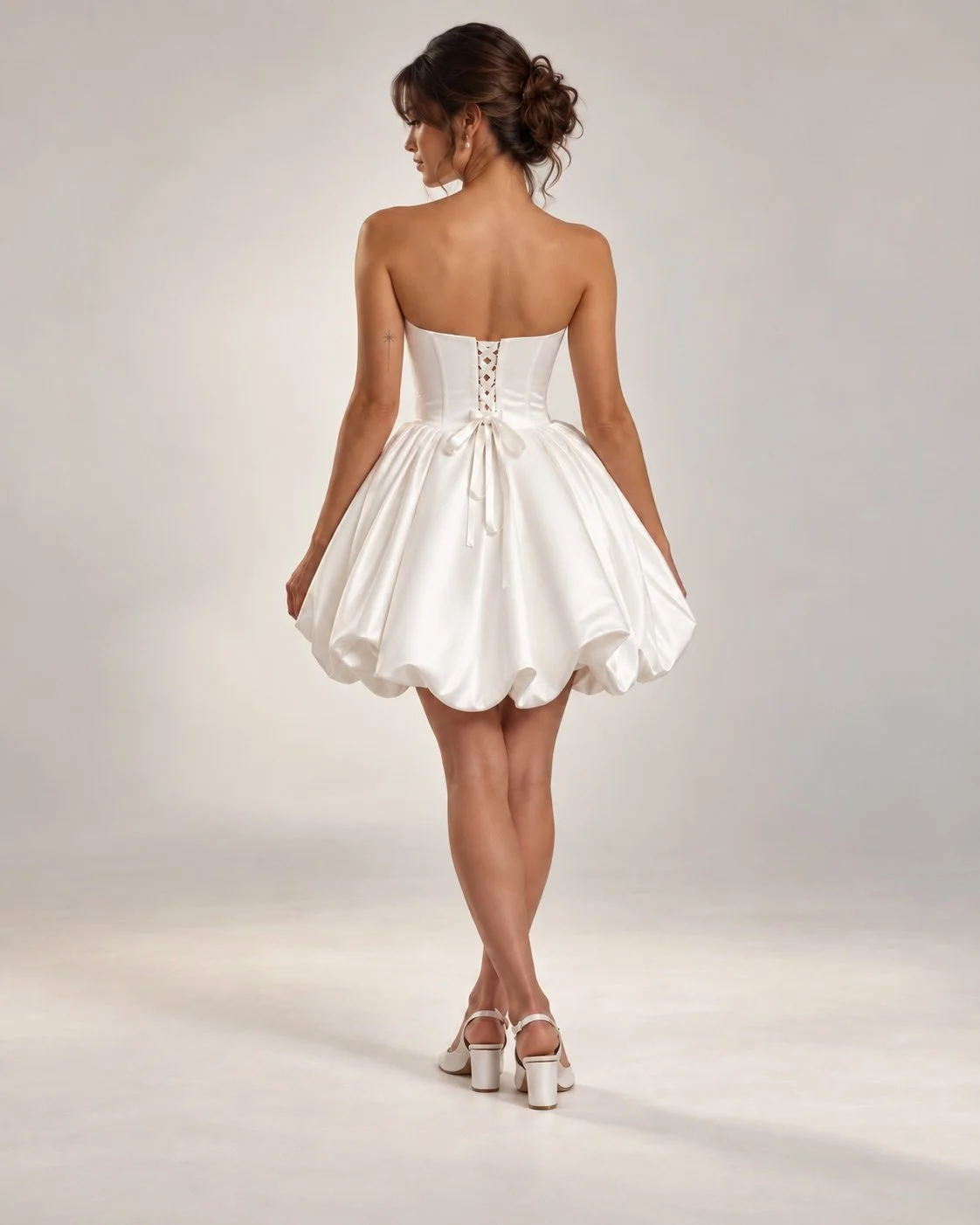Back view of VERONA satin bridal mini dress with adjustable lace-up corset back and voluminous bubble skirt at Spellbound Bridal Wicklow