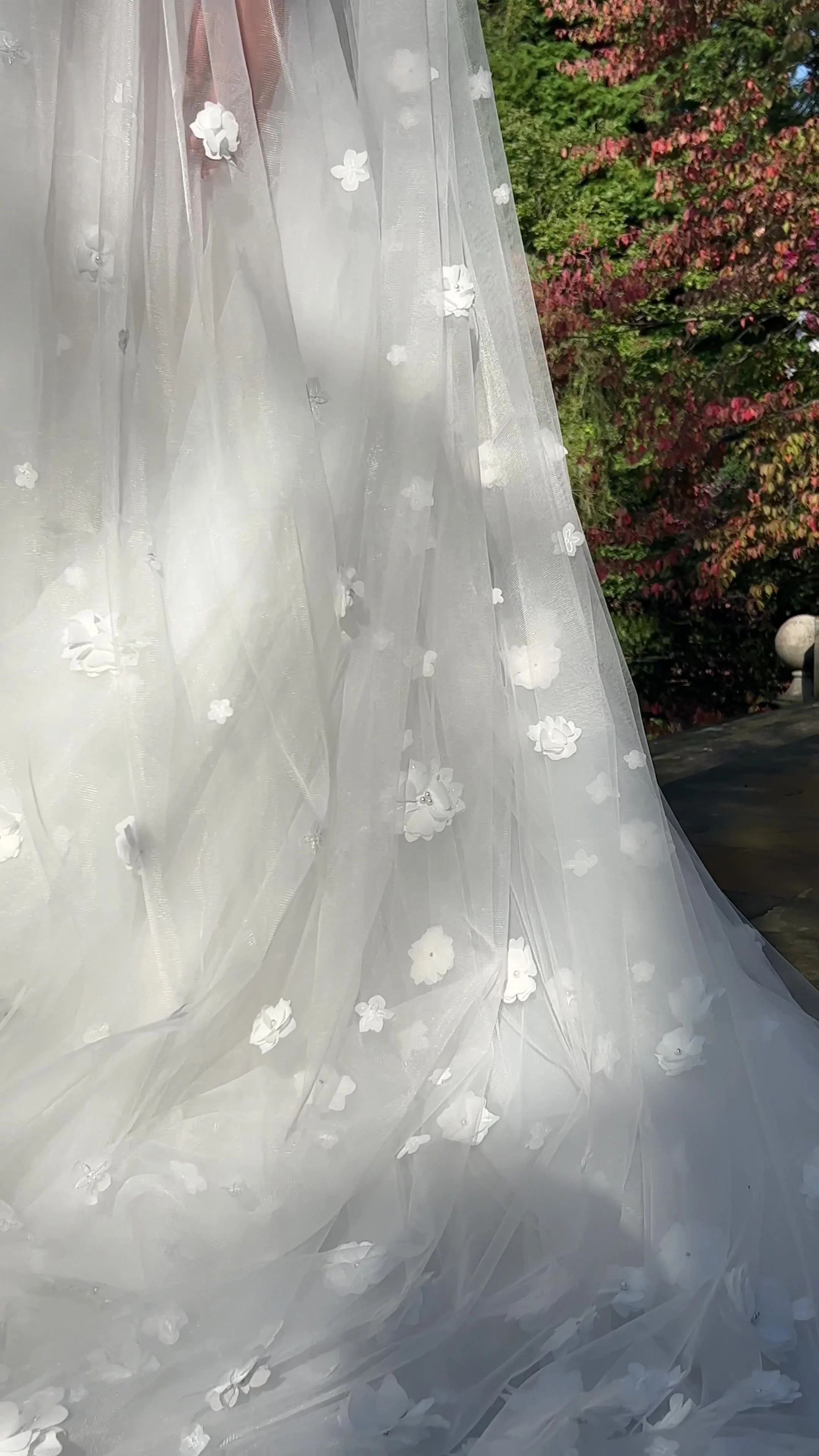 Naomi cathedral-length bridal veil with delicate 3D floral appliqué on soft sheer tulle.