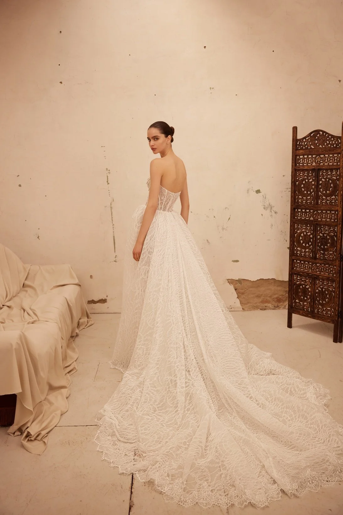 Jamini wedding dress by Olya Mak featuring a strapless corset bodice, intricate lace embellishment, subtle sparkle and flowing ivory A-line skirt. Exclusive at Spellbound Bridal, Arklow, Co Wicklow, Ireland.