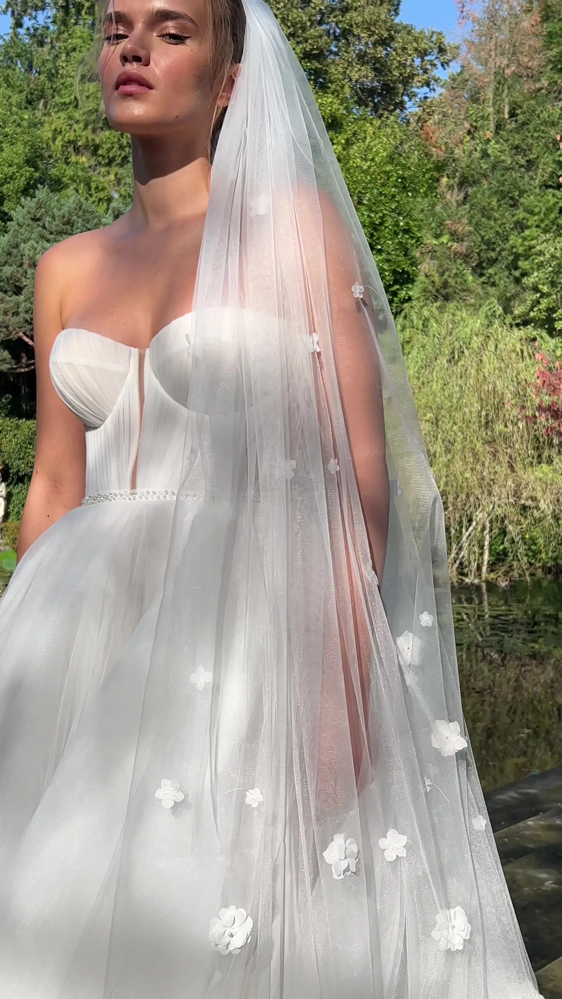 Naomi cathedral-length bridal veil with delicate 3D floral appliqué on soft sheer tulle.