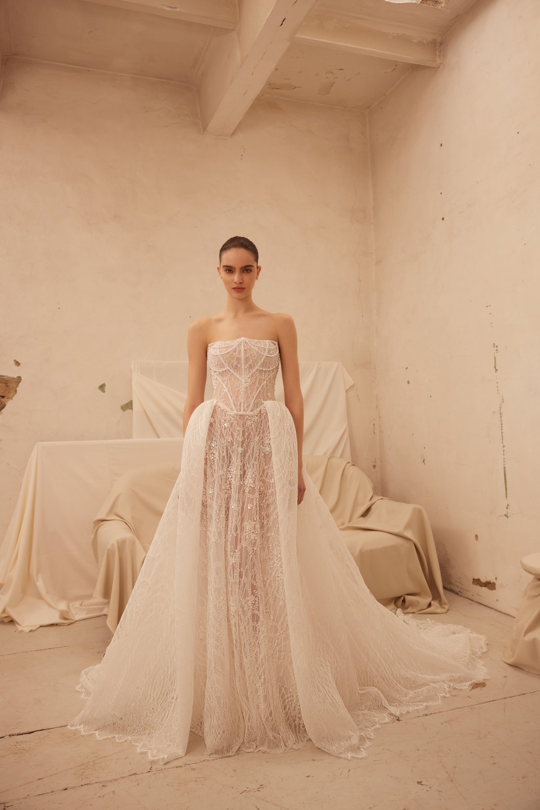 Jamini wedding dress by Olya Mak featuring a strapless corset bodice, intricate lace embellishment, subtle sparkle and flowing ivory A-line skirt. Exclusive at Spellbound Bridal, Arklow, Co Wicklow, Ireland.