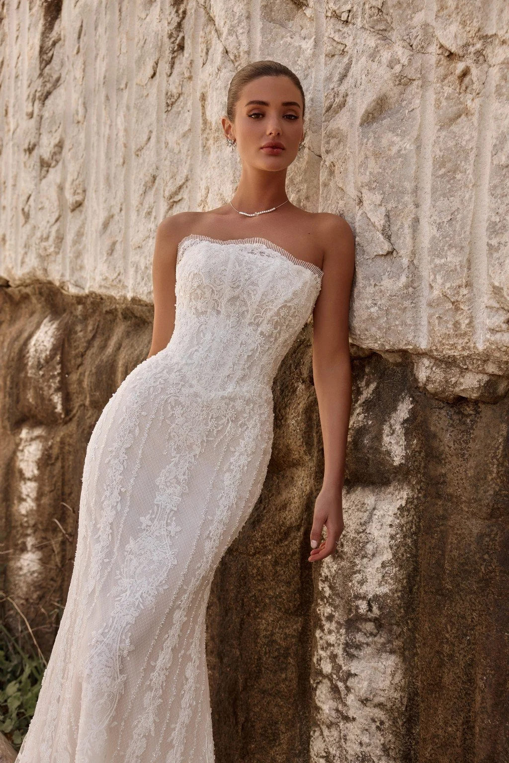 Discover Persephone by Katy Corso at Spellbound Bridal. An embellished guipure lace wedding dress with an optional sculpted corset overskirt for two striking bridal looks.