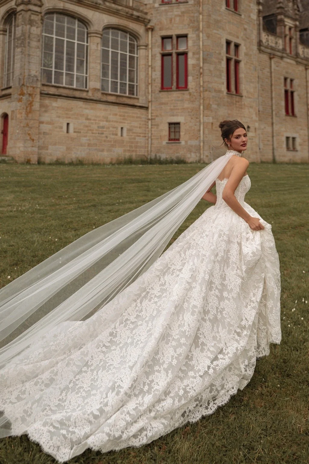 AVEL is a Chantilly lace ballgown style wedding dress. Brides can choose to complete their wedding day look with a lace choker that extends into a long cape-style train. Exclusively available at Spellbound Bridal, Wicklow, Ireland.
Dress Designer: Ka